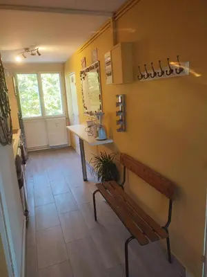 a room with a bench and a table and a counter at Grand appartement de charme calme et lumineux parking compris in Aix-en-Provence