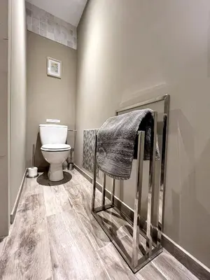 a bathroom with a toilet and a towel at Le Domaine de Piedmoure, Gîtes et chambres, piscine, terrasses privatives in Sault-de-Vaucluse