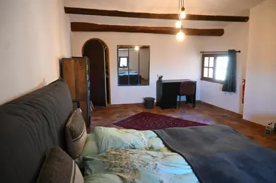 a living room with a couch and a table at Maison Porte Heureuse in Roussillon