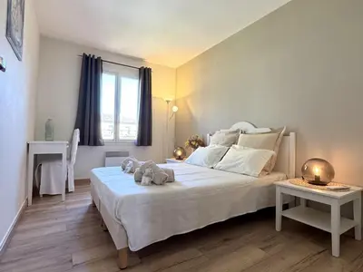 a bedroom with a large white bed and a window at Maison Calme 6 Pers. au Golf Pont Royal - Piscine, Terrasse, Parking, Clim, Fibre - 13370 Mallemort - FR-1-658-24 in Mallemort