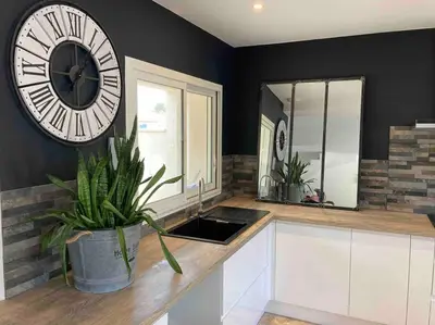 a kitchen with a large clock on the wall at Villa les Romarins in Saint-Didier