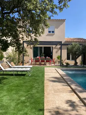 a backyard with a pool and a house at Villa les Romarins in Saint-Didier