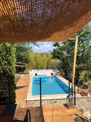 a swimming pool in the middle of a yard at Le Jas Gabriel in Murs