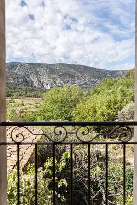 a view of a mountain from a balcony at La Bastide du Mourre - Fontenille Collection in Oppède