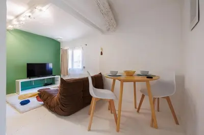 a living room with a table and a couch at L'Aixquis - T2, Vieille Ville in Aix-en-Provence