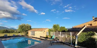 a swimming pool in a yard with a house at Location Gite avec Piscine Luberon ARTEMISS in Apt