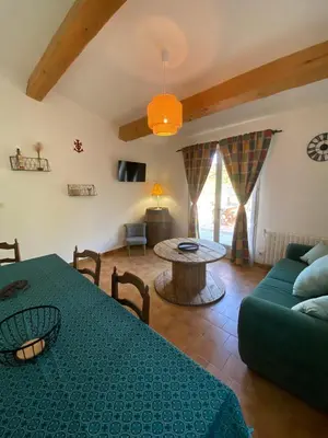 a living room with a table and a couch at Gîte Lou Gardian in Aureille