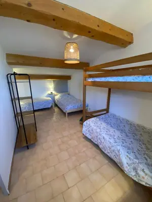a room with two bunk beds and a ladder at Gîte Lou Gardian in Aureille
