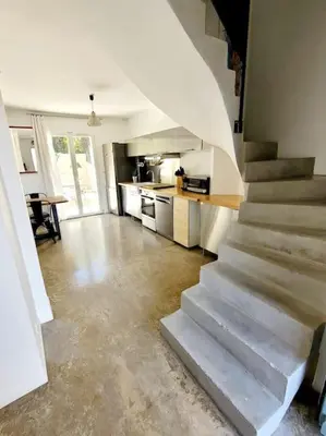 a kitchen with a staircase in a house at Maison de village 4 étoiles avec piscine privee in Villars