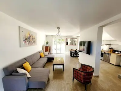 a living room with a couch and a table at Maison de village 4 étoiles avec piscine privee in Villars