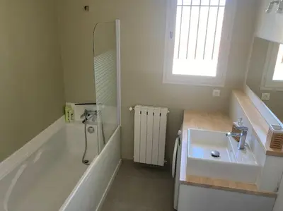 a bathroom with a tub and a sink and a shower at Maison familiale au pied du Mont Ventoux in Mazan