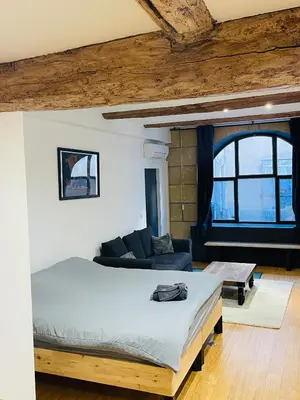 a bedroom with a large bed and a couch at Aix-en-Provence, studio atypique quartier hyper centre in Aix-en-Provence
