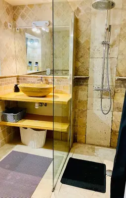 a bathroom with a glass shower and a sink at Aix-en-Provence, studio atypique quartier hyper centre in Aix-en-Provence