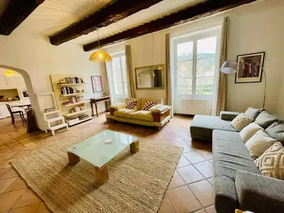 a living room with couches and a coffee table at Notre Dame des Anges DUPLEX in Rustrel