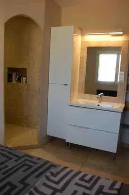 a bathroom with a white sink and a mirror at La villa castellas in Carpentras