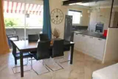 a kitchen and dining room with a table and chairs at La villa castellas in Carpentras