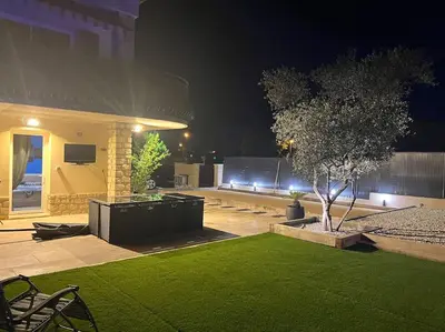 a house with a lawn in front of it at night at La villa castellas in Carpentras