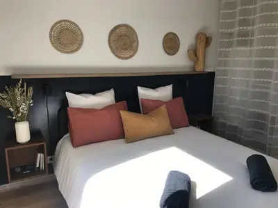 a bedroom with a large white bed with pillows at Charmant appartement ensoleillé-Terrasse - PARKING Gratuit - Isle sur la Sorgue in LʼIsle-sur-la-Sorgue