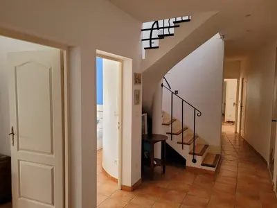 a staircase in a home with a white stair case at La Villa des Lavandes - A 300m du Centre, au calme, et au vert ! in LʼIsle-sur-la-Sorgue