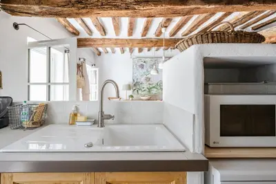 a kitchen with a sink and a microwave at Chez Fanny in Bédoin