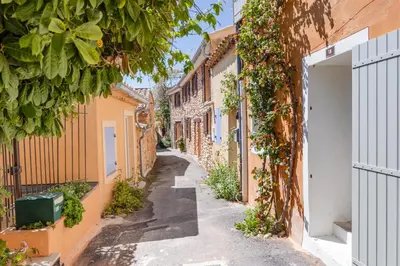 an alley in an old town with buildings at Chez Fanny in Bédoin