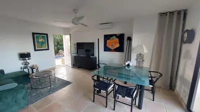 a living room with a glass table and chairs at Appartement entier Vue sur PAYS D Aix in Aix-en-Provence
