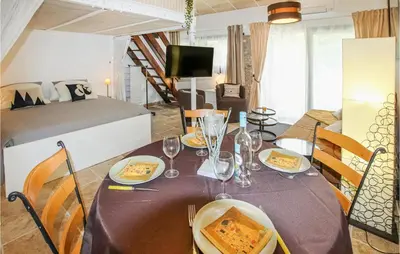 a dining room with a table with food on it at Beautiful Home In Carpentras in Carpentras