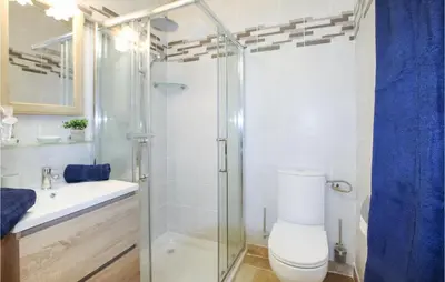 a bathroom with a toilet and a glass shower at Beautiful Home In Carpentras in Carpentras