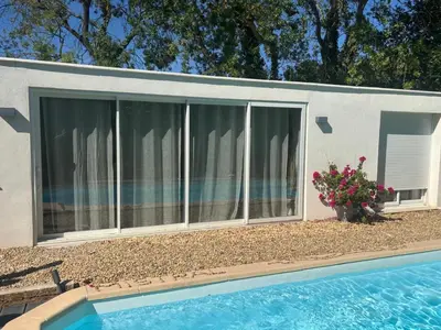 a house with a swimming pool next to a building at Échappée Mistral - Détente Jacuzzi privé & Brasero in Eyragues