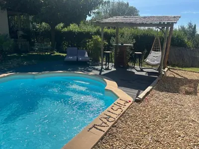a swimming pool in a backyard with a gazebo at Échappée Mistral - Détente Jacuzzi privé & Brasero in Eyragues