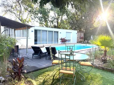a patio with a table and chairs next to a pool at Échappée Mistral - Détente Jacuzzi privé & Brasero in Eyragues