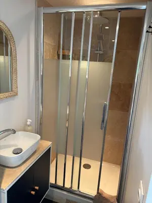 a bathroom with a shower and a sink at Échappée Mistral - Détente Jacuzzi privé & Brasero in Eyragues