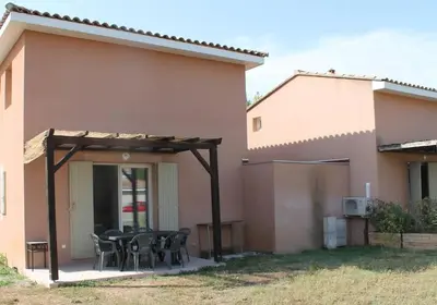 a patio with a table and chairs next to a house at chez bruno et marie jo in Saint-Saturnin-lès-Avignon