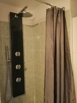 a shower with a shower curtain in a bathroom at chez bruno et marie jo in Saint-Saturnin-lès-Avignon