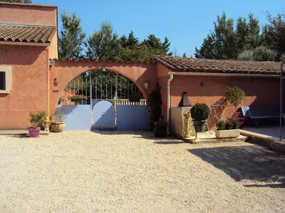 a building with a gate and a fence at La Douloire in Pernes-les-Fontaines