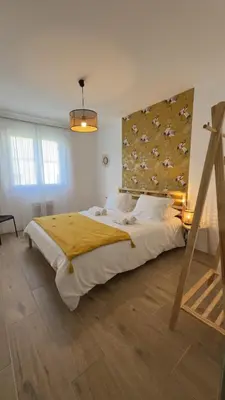 a wooden table with a lamp and a chair at Maison Le Clos Du Moulin 3 - Climatisée, jardin & parking gratuit - 3 chambres doubles - 10 min Avignon in Entraigues-sur-la-Sorgue