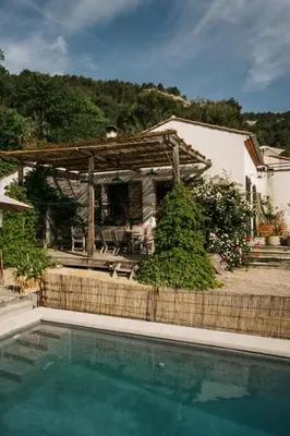 a house with a swimming pool in front of a house at Hidden gem with panoramic views in Fontaine-de-Vaucluse