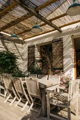 a wooden table and chairs on a wooden deck at Hidden gem with panoramic views in Fontaine-de-Vaucluse