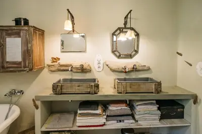 a bathroom with two sinks and two mirrors at Hidden gem with panoramic views in Fontaine-de-Vaucluse