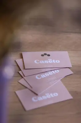 three pink cards sitting on top of a table at Casëto Luberon in Apt