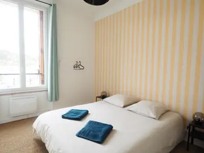 a bedroom with a white bed with two towels on it at Casëto Luberon in Apt