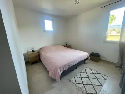 a small bedroom with a bed and a window at Le Lourmarinois in Lourmarin