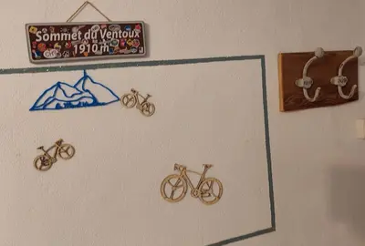 a wall with three bikes and a sign on it at Mon Ventoux in Modène