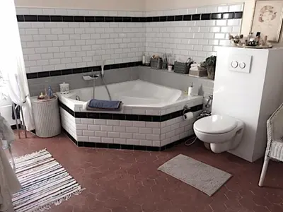 a bathroom with a tub and a toilet at La Bégude des Alpilles in Orgon