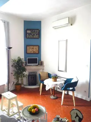 a living room with a table and a fireplace at La Bégude des Alpilles in Orgon