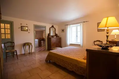 a bedroom with a bed and a dresser and a mirror at Luberon - Mas du Grand Saint Julien in Rustrel
