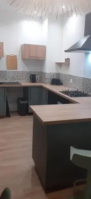 a kitchen with a counter top and a stove at La PAUSE Salonaise 