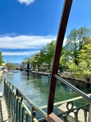 a view of a river from a bridge at Lou Paseo : Appartement Brocante centre historique in LʼIsle-sur-la-Sorgue