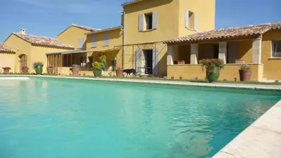 a swimming pool in front of a house at La Grande Bouisse gites avec piscine dans le Luberon, Provence in Céreste