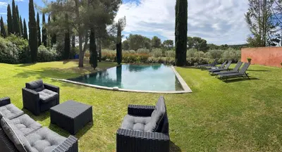 a pool with couches and chairs in a yard at Petite Toscane Villa close to Aix en Provence in Ventabren